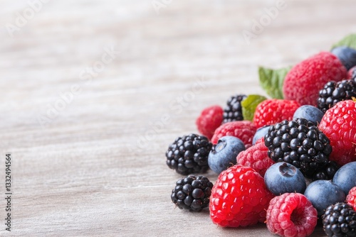 Wallpaper Mural close-up of freshly picked berries and fruits artistically scattered on rustic wooden table with ample copy space for Torontodigital.ca