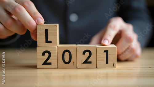 Symbolizing New Beginnings: A Hand Places Wooden Cubes on a Progress Bar Transitioning from 2020 to 2021 - Stock Photo Concept with Empty Space for Customization