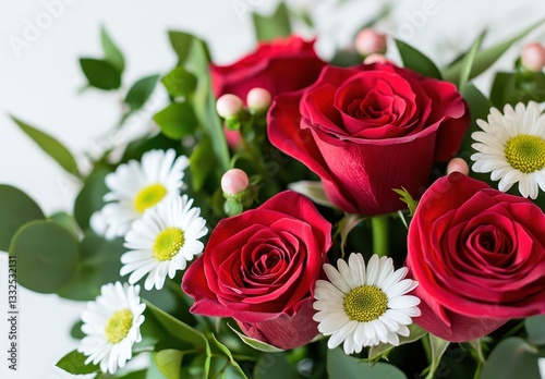 Beautiful arrangement of red roses and white daisies with green leaves, perfect for celebrations, weddings, and special occasions in a bright setting