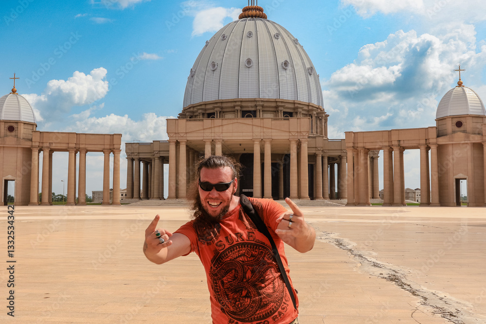 Tourist enjoys a sunny day at Basilica of Our Lady of Peace in Yamoussoukro, Ivory Coast
