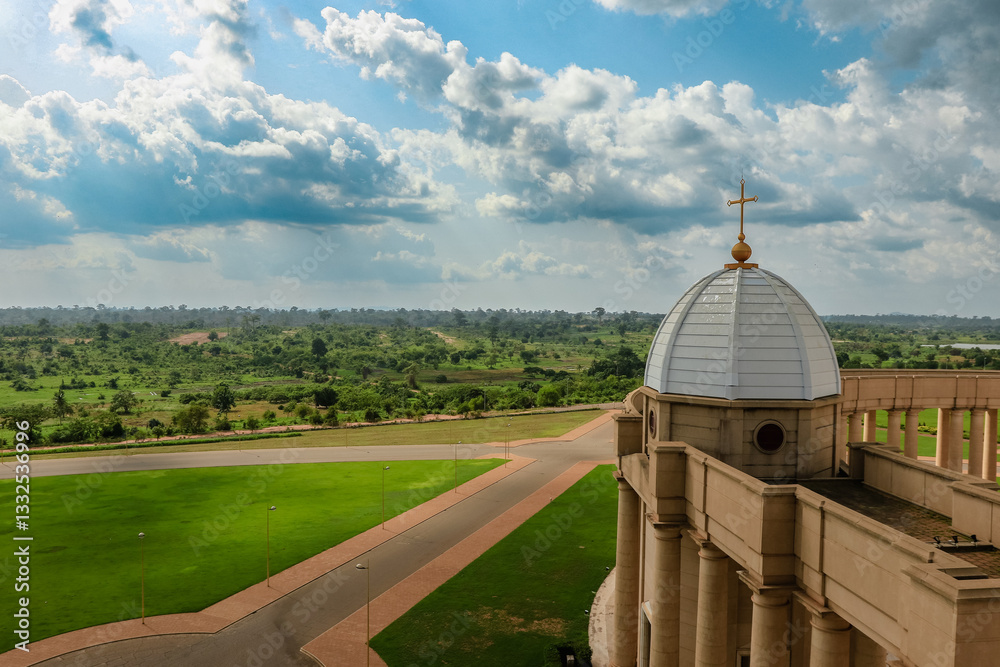 Basilica of Our Lady of Peace overlooking expansive green landscape in Yamoussoukro