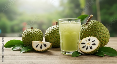Soursop juice served in a glass with whole and sliced soursop fruits nearby in a garden