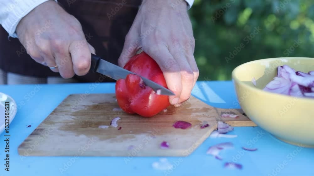 male chef chopping vegetables for barbecue in backyard outdoors male chef chopping vegetables for barbecue in backyard outdoors