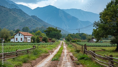 Serene countryside scene featuring a charming white farmhouse nestled amidst lush green fields and majestic mountains under a cloudy sky.