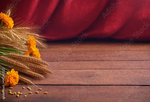 Wooden table decorated with orange marigold flowers and sprouts with wheat ears, celebrating harvest, for Indian Vaisakhi festival. Hindu festival background for banner or poster with copy space.	