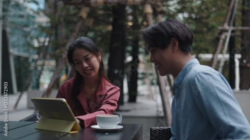 Wallpaper Mural Asian couple using tablet and drinking coffee at outdoor cafe Torontodigital.ca