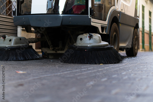 street cleaning machine passing through pedestrian street