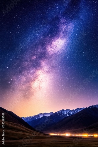 A breathtaking night sky showcases the Milky Way, set against majestic mountains and a softly lit valley below, This stunning landscape is ideal for nature-themed projects, astronomy-related content