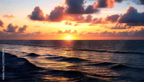 a sunset over an ocean with waves crashing on the shore. photo