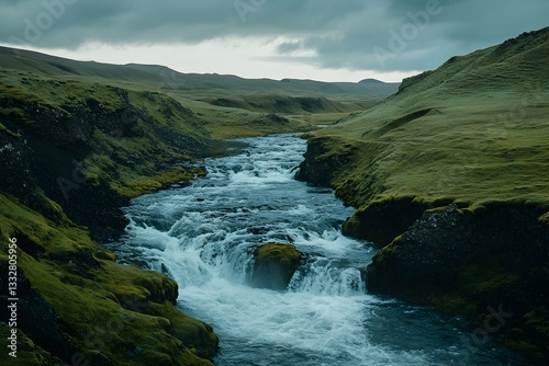 Serene waterfall in a lush green valley at sunset, showcasing Iceland's breathtaking natural beauty
