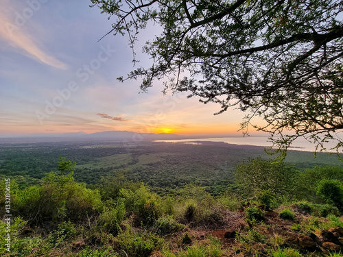 Enjoy the tranquility of a sunset over a green landscape, immersed in natures beauty Lake Manyara Tanzania Africa