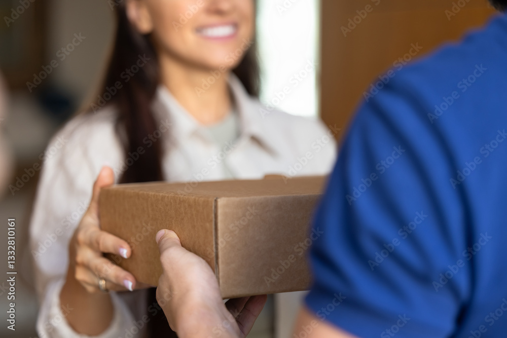 Female customer taking parcel from delivery logistic service worker man, receiving ordered purchase, smiling, standing at home entrance. Courier giving package to recipient cropped shot Female customer taking parcel from delivery logistic service worker man, receiving ordered purchase, smiling, standing at home entrance. Courier giving package to recipient cropped shot