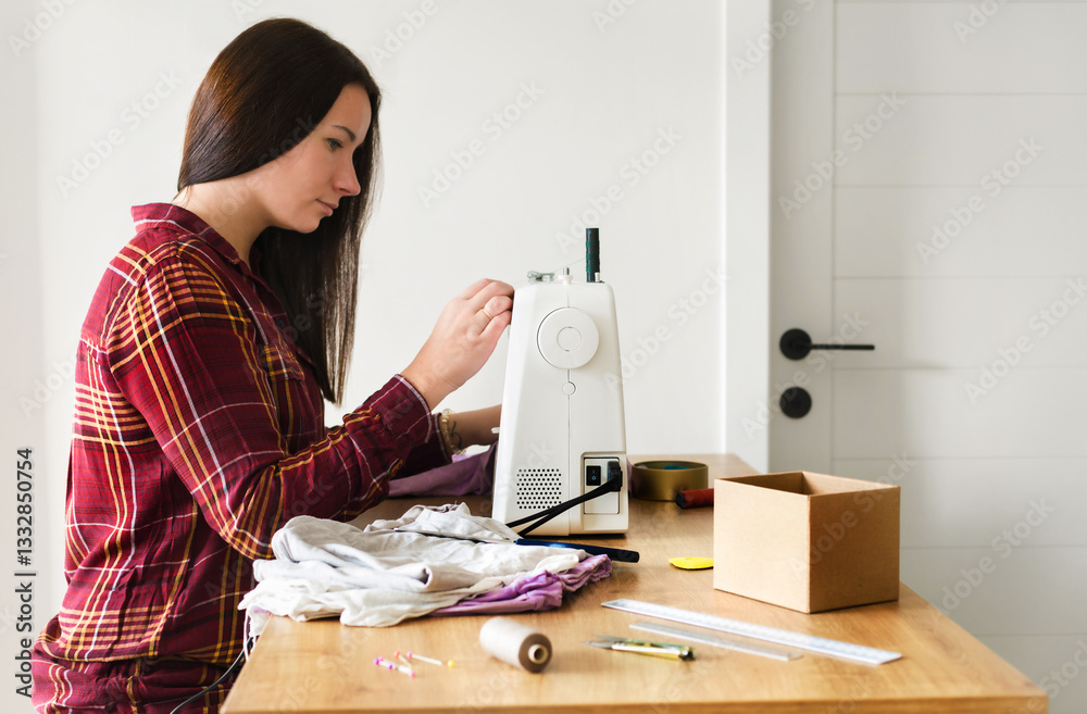 A young woman working on a sewing machine at home, creating handmade clothing. Concept of small business, craftsmanship, tailoring