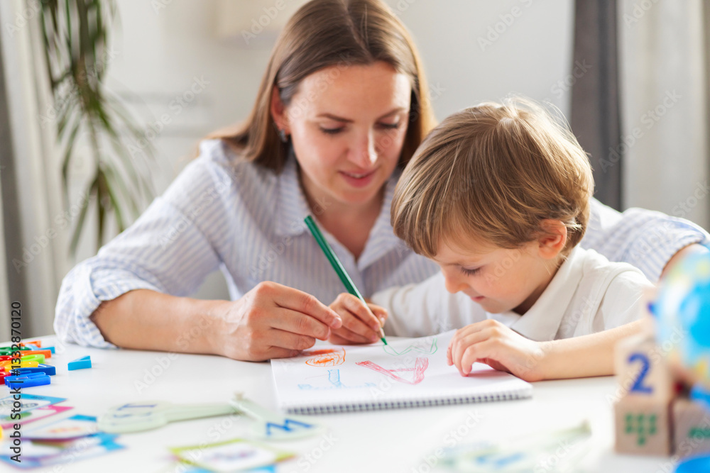 Mother teaching child to draw in homeschool setting Mother teaching child to draw in homeschool setting