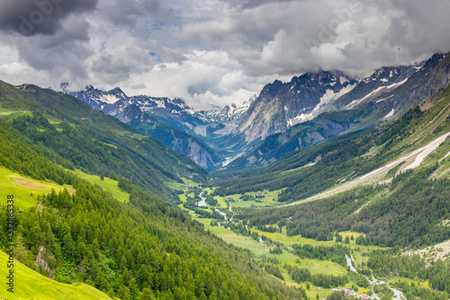 Beautiful mountain landscape of the Alps in summer on tour du Montblanc area near Courmayeur village in Val Ferret valley in Italy. European Alps stunning views of green valley with colorful flowers