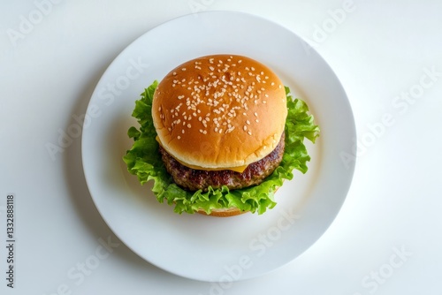 Obraz na płótnie Delicious homemade burger with fresh lettuce and sesame seed bun on a white plate ready to be enjoyed at lunchtime w salonie