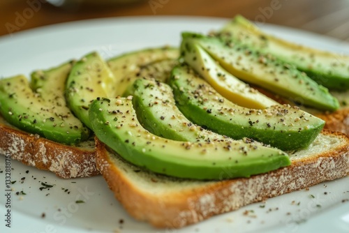 Obraz na płótnie Delicious avocado slices on toasted bread garnished with seasoning for a healthy snack w salonie