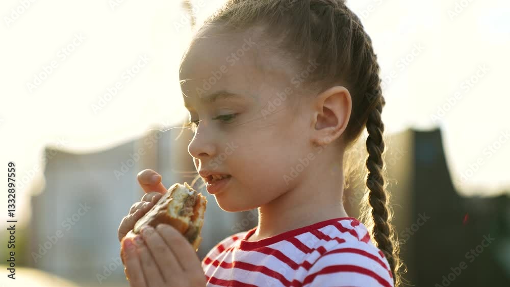 Funny cute little girl fooling eating big piece of fast food burger ...