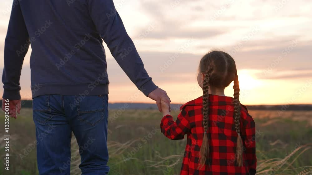 Daughter father holding hands at sunset. Little kid child baby man daddy strolling forward together toward at sunrise. Concept of personal growth development upbringing transfer of generation values. Daughter father holding hands at sunset. Little kid child baby man daddy strolling forward together toward at sunrise. Concept of personal growth development upbringing transfer of generation values.