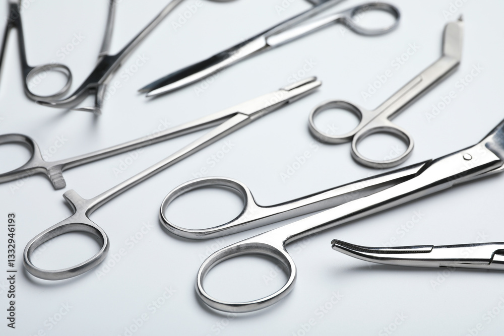 Different surgical tools on light gray background, closeup Different surgical tools on light gray background, closeup