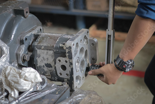 Foto Close up Assembly and installing Gear pump or Scavenge pumps with blur background, These pumps are useful to propel used oil back to an oil sump or tank under certain conditions