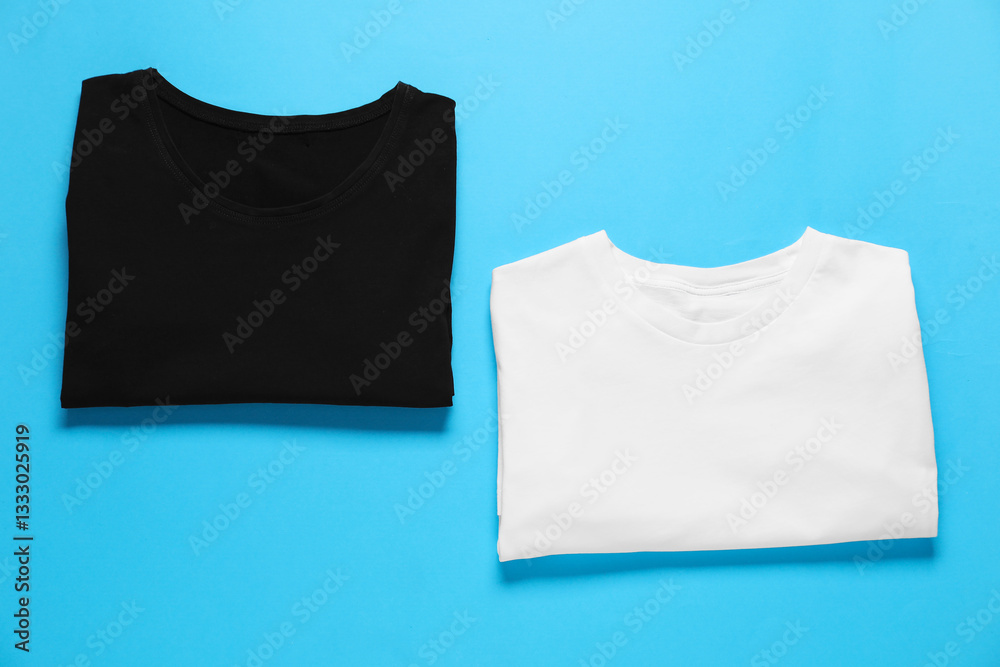 Blank t-shirts for branding on light blue background, flat lay. Mockup for design Blank t-shirts for branding on light blue background, flat lay. Mockup for design