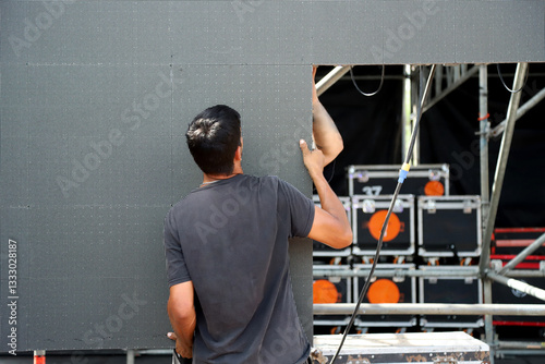 Fotografie Technicians working on stage assembling giant LED screen panels for rock event