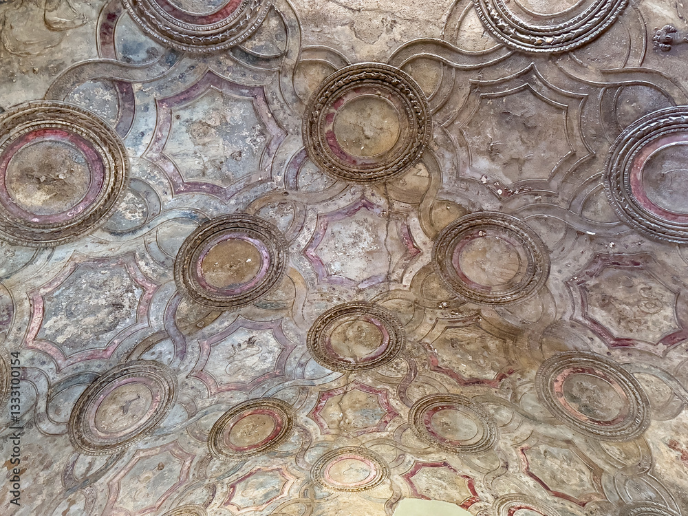 Fototapeta premium Pompeii, Campania, Italy - July 6, 2024: Ancient Roman City ruins on Via Dell' Abbondanza. Terme Stabiane building, the Stabian Baths. Detail of ceiling decorations