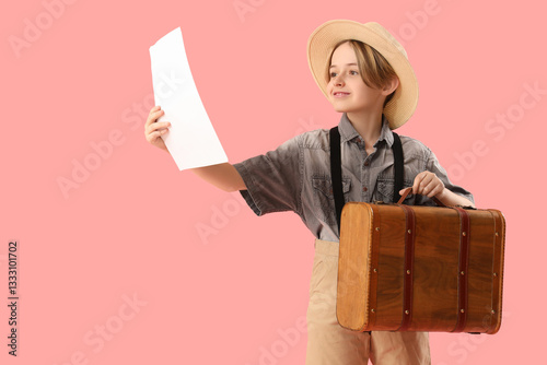 Little actor with suitcase and film script on pink background