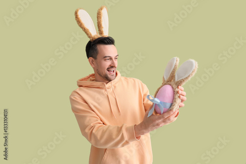 Young man with bunny ears a...
