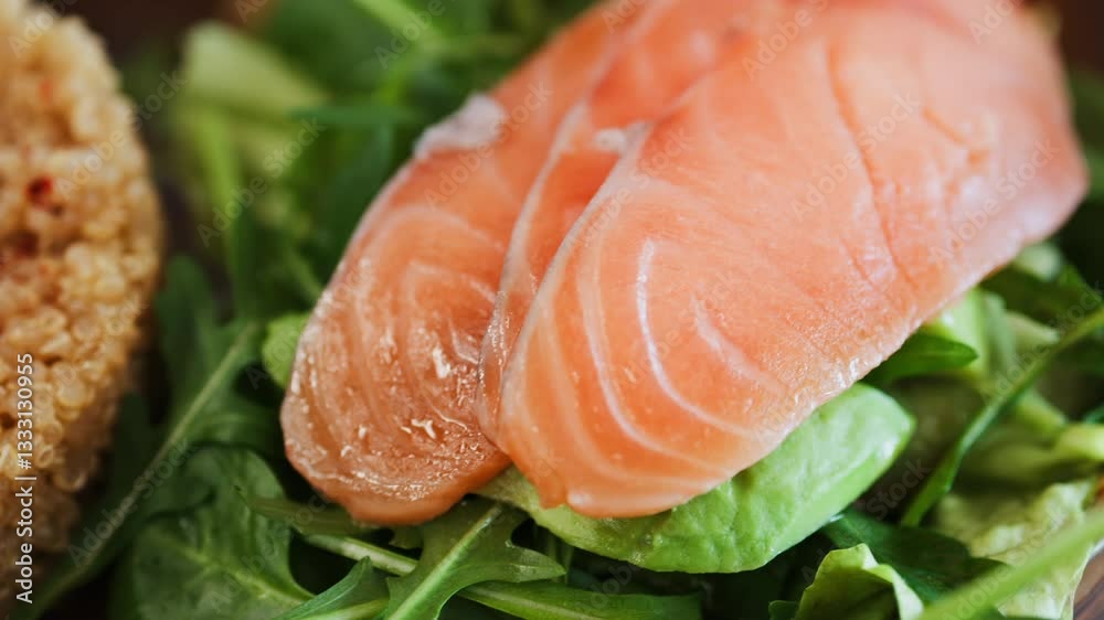 Close up of a quinoa salad with salmon and spinach at a restaurant Close up of a quinoa salad with salmon and spinach at a restaurant