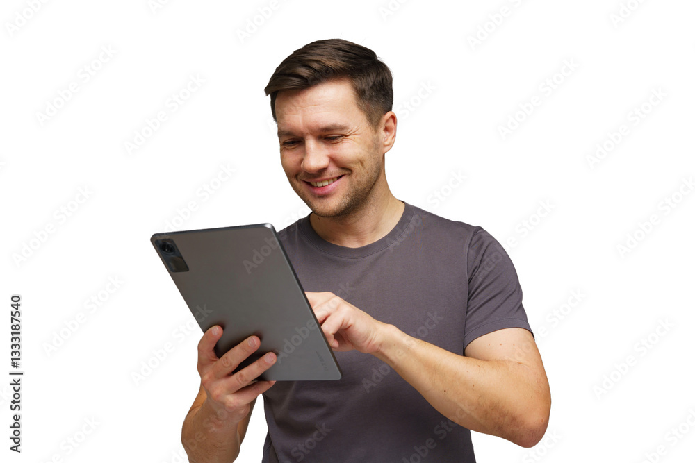Young man smiling while using tablet in a bright setting, engaged in online activity Young man smiling while using tablet in a bright setting, engaged in online activity