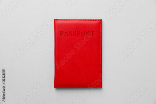 Passport in bright cover on grey background, top view