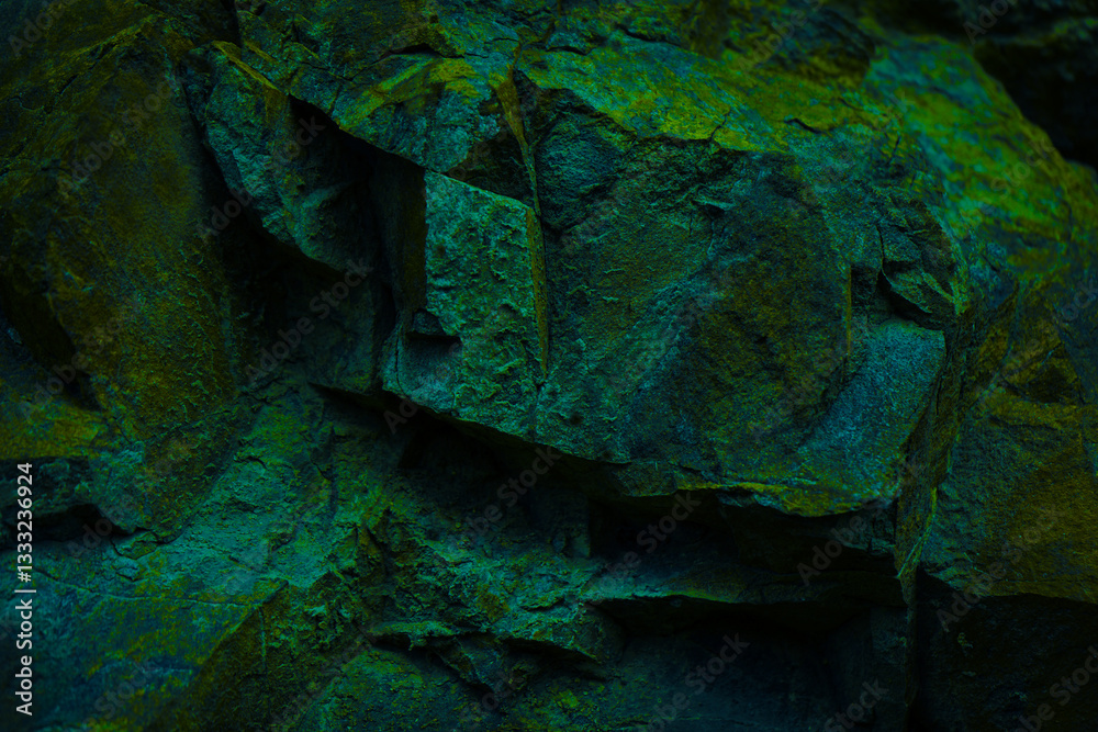 Black dark blue emerald green rock texture background. Toned. Rough mountain surface with moss. Close-up. Nature. Design.