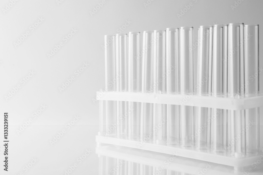 Obraz premium Empty test tubes on light background, space for text. Laboratory glassware