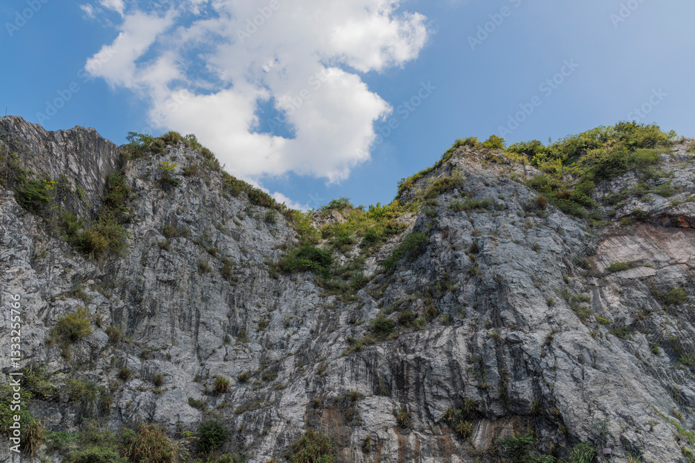 A rocky cliff under a blue sky A rocky cliff under a blue sky
