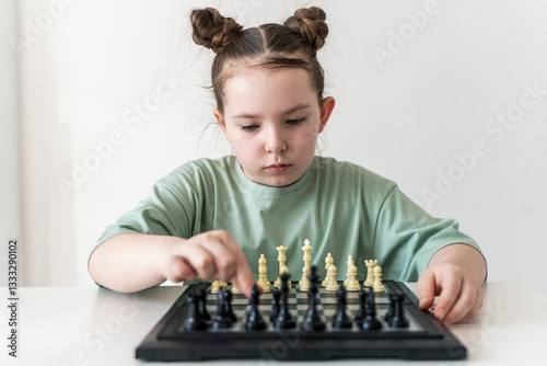 Little girl playing chess. Selected Focus. High quality photo