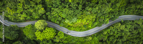 Aerial view green forest and asphalt road, Top view forest road going through forest with car adventure, Ecosystem ecology healthy environment road trip travel.