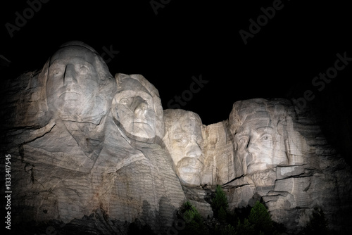 The iconic Mount Rushmore, beautifully illuminated during the night, showcasing the artistic mastery and grandeur of this monumental tribute to American history.