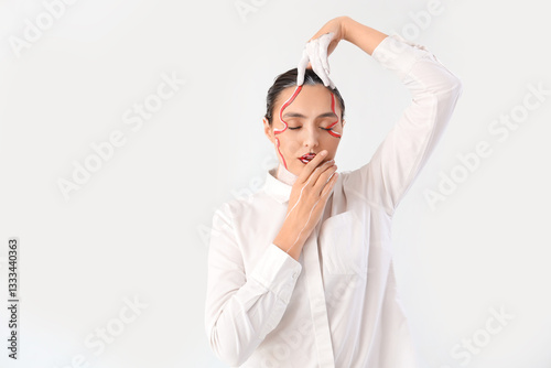 Young woman with painted fa...