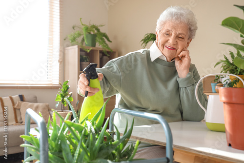 Senior gardener watering al...