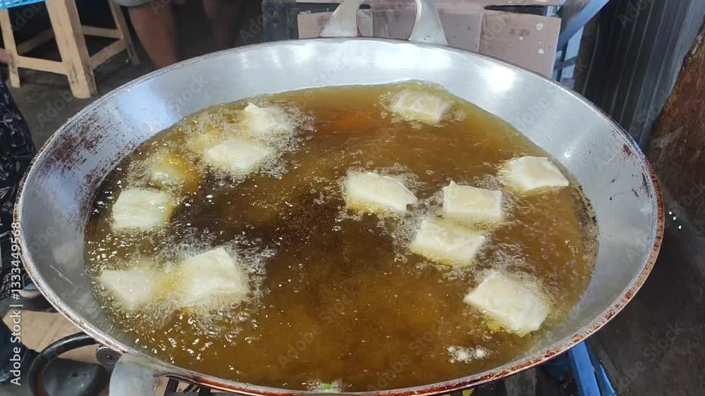 Street food vendors are frying various fried foods such as fried tempeh and stuffed tofu for buyers looking for takjil during the fasting month of Ramadan.