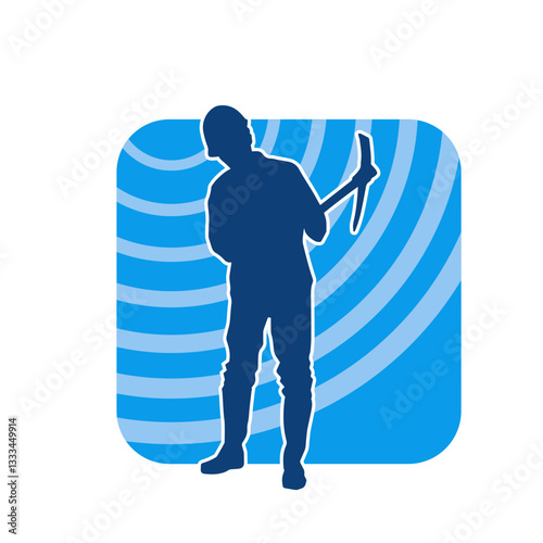 Silhouette of a construction worker in action with a pick axe tool. Silhouette of a miner labour in heavy duty work.