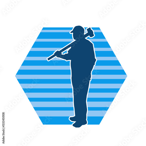 Silhouette of a worker in action pose using his sledge hammer tool.