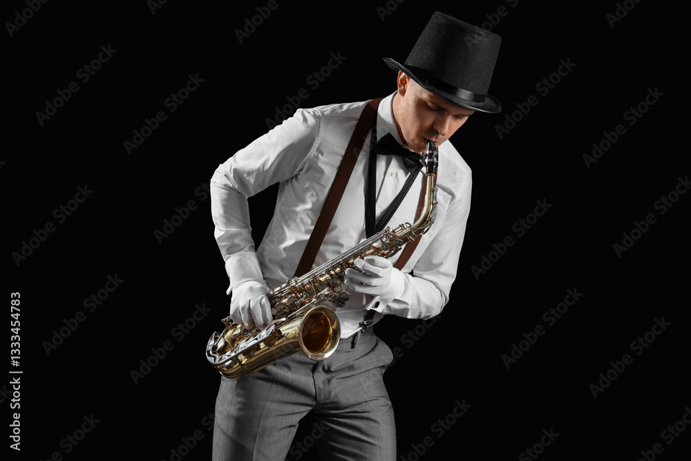 Naklejka premium Male artist playing saxophone on black background