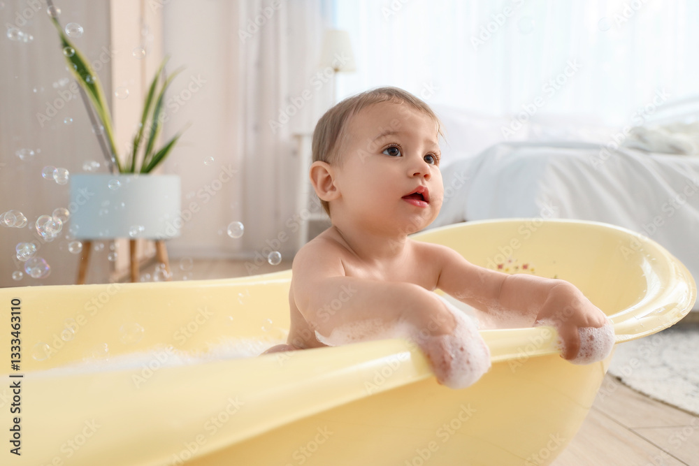Cute little baby with soap bubbles bathing in bedroom Cute little baby with soap bubbles bathing in bedroom