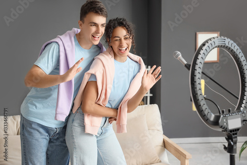 Happy young couple recordin...