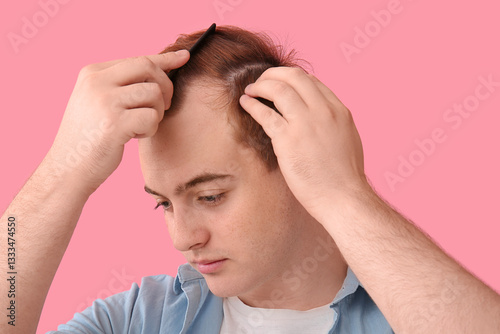 Young redhead man with hair...