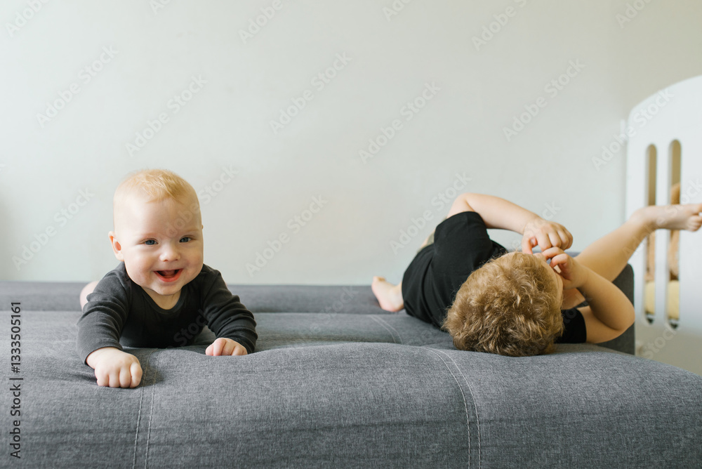 Baby Crawling And Boy Relaxing