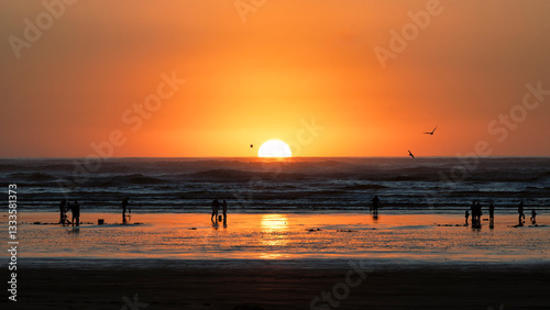 Fototapeta Naklejka Na Ścianę i Meble -  A tranquil beach scene showcasing a stunning sunset over the waves, perfect for capturing the beauty of nature and the soothing feeling it evokes in viewers.